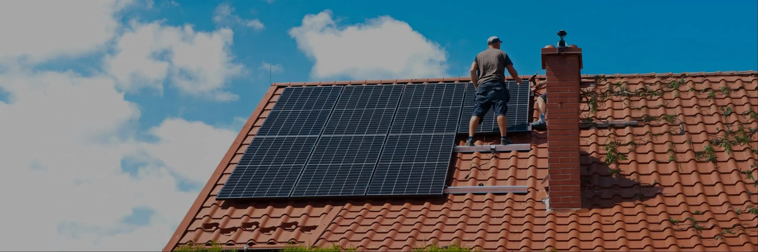 person on a roof with solar panels