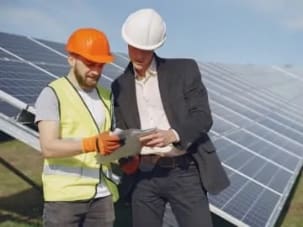engineers assessing solar panels