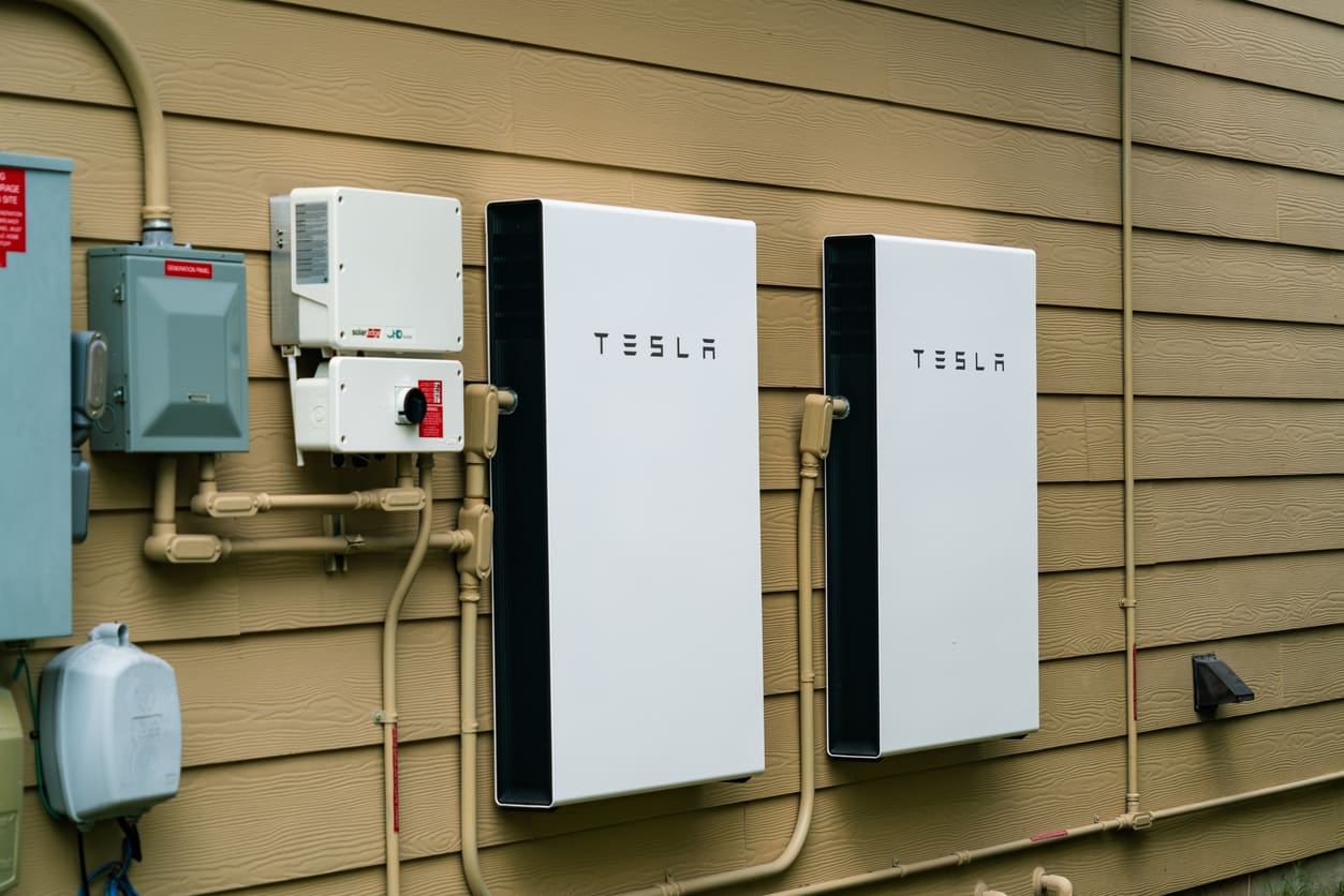 2 tesla battery storage systems on a wall